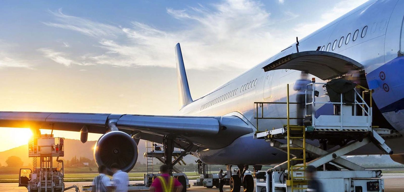 Cargo aircraft being loaded at dusk