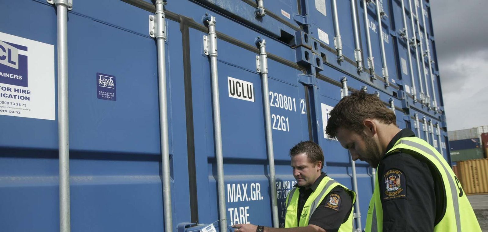 Officers inspecting containers